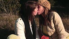 lesbian couple shares outdoor kiss then uses strapon for heated action