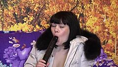This milf slips into her down coat with fur hood and starts sucking that big dildo in all sorts of positions for homemade fetish fun