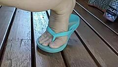 Mature squats spreads legs wide outdoors