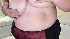 Thick busty granny strips naked showing off her huge tits and hairy pussy