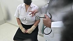 doctor examines patient closely in hospital room