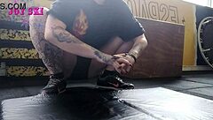 sexy tattooed alternative stretches teasingly in gym