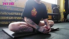 sexy tattooed alternative stretches teasingly in gym