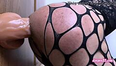 The shemale in fishnets and cage pushes boundaries with huge dildo solo toy play
