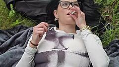 smoking on grass showing my huge natural tits boobs in sun garden