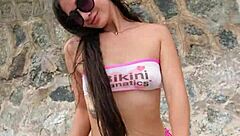 Brunette babe chills bikini flashing public beach