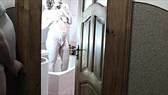 Naked blonde milf showers as roommate jerks cock watching cumshot