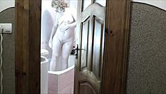 Naked blonde milf showers as roommate jerks cock watching cumshot