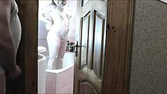 Naked blonde milf showers as roommate jerks cock watching cumshot