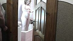 Naked blonde milf showers as roommate jerks cock watching cumshot