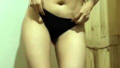 the colombian beauty sways her hips in a slow sensual dance under dim lights