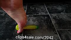 barefoot femdom tramples with banana toy underfoot