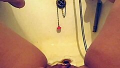 Busty milf bathes in warm piss shower, wet curves glistening in tub