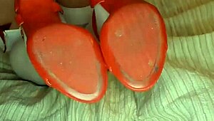 Slowly removing red shoes and white silk stockings