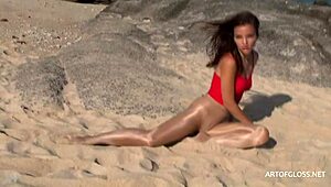 Monika models shiny pantyhose on beach