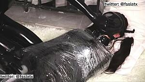 Asian Latex Catsuit Woman in Gasmask Bondage Play