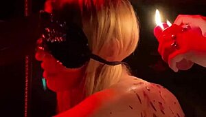 Handcuffed blonde endures hot wax backstage