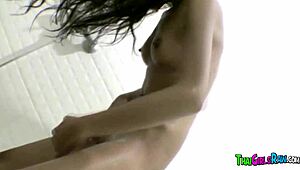 Skinny Asian girl teases in the shower while shaving her hairy cunt and exposing her shaved pussy.