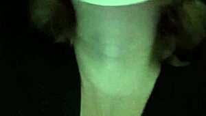 Petite girl gently caresses her natural big tits through black shirt and bra