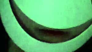 Petite girl gently caresses her natural big tits through black shirt and bra