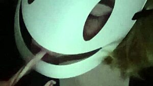 Petite girl gently caresses her natural big tits through black shirt and bra