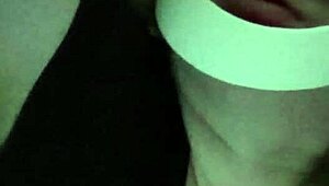 Petite girl gently caresses her natural big tits through black shirt and bra