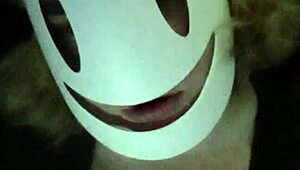 Petite girl gently caresses her natural big tits through black shirt and bra