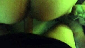 In the dimly lit room, a thick white ass bends over for intense anal fucking in doggystyle position