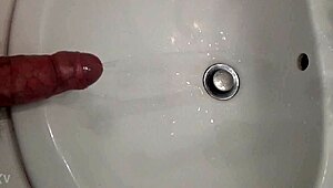 Guy pisses with a hard cock
