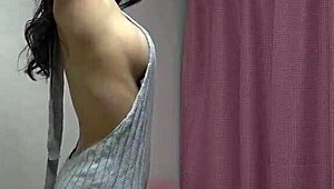 Remi with natural figure gets dressed on webcam.