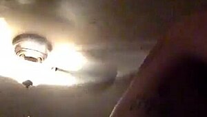 In this retro blue film, a tattooed performer engages in intense riding