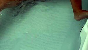 Amateur pornstar masturbates cock in hydro massage bathtub, focusing on sexy boobs