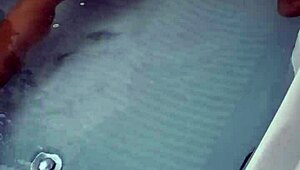 Amateur pornstar masturbates cock in hydro massage bathtub, focusing on sexy boobs