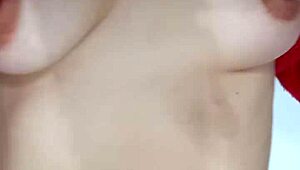 Playing with a belt, spanking my natural tits hard.