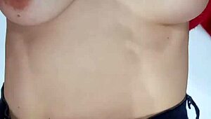 Playing with a belt, spanking my natural tits hard.