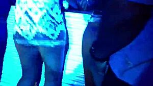 Girl sits on Ciroc bottle while eating another girl out on stage during wild show. Crowd cheers loud.