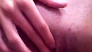 A tattooed woman enjoys solo time in the bathroom, exploring her body with gentle touches.