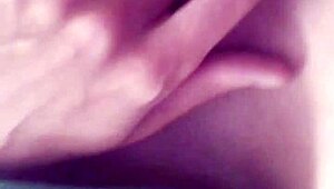 A tattooed woman enjoys solo time in the bathroom, exploring her body with gentle touches.