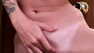 A tattooed woman enjoys solo time in the bathroom, exploring her body with gentle touches.