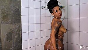 Ariella Ferraz relaxes in the bath with her lover and a vibrator. Close-up views of her natural tits and tattoo.