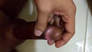 The ebony shaft and scrotum is well groomed and receives a superb solo massage to a pleasing climax of creamy fluids