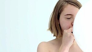 Young looner babe blowing and popping her first balloon, wow!