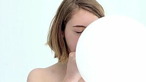 Young looner babe blowing and popping her first balloon, wow!