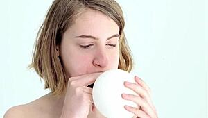 Young looner babe blowing and popping her first balloon, wow!