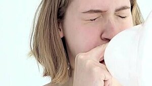 Young looner babe blowing and popping her first balloon, wow!