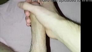 A young amateur massages his cock in a solo homemade masturbation session.