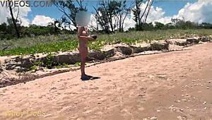 Watch my wife play football nude on the public clothed beach? She's flashing her big tits!