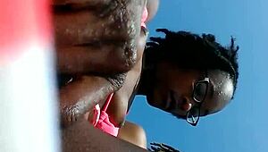 Look at this ebony slut fingering her pussy on the beach!