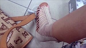 Wonderful sexy feet trying on sandals in shoe shop