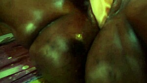 Dude, this hot ebony milf is banging herself with a dildo! Her body and pussy are unreal.